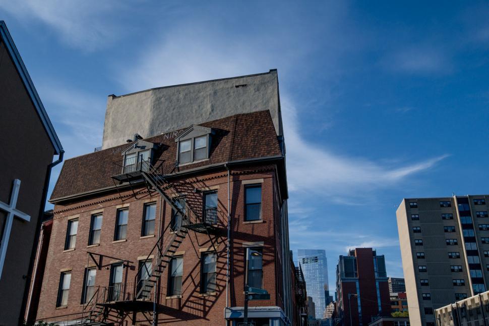 Free Stock Photo Of Red Brick Building With Fire Escape Against Sky