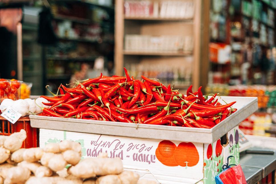 Free Stock Photo Of Bright Red Chili Peppers Stacked In A Market Stand