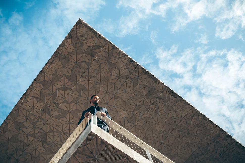 Free Stock Photo Of Man Standing On Ladder In Front Of Building