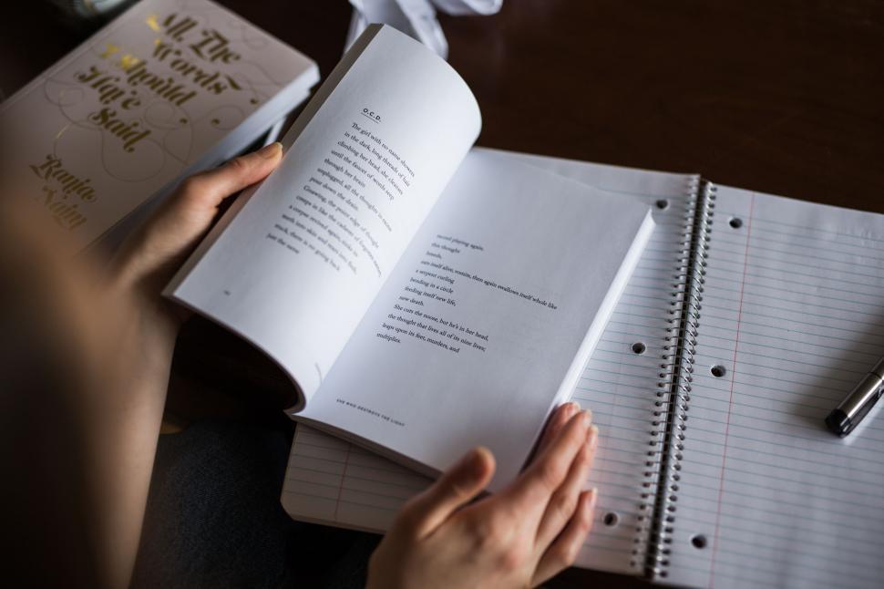 Free Image of Person Sitting at Table With Notebook and Pen 