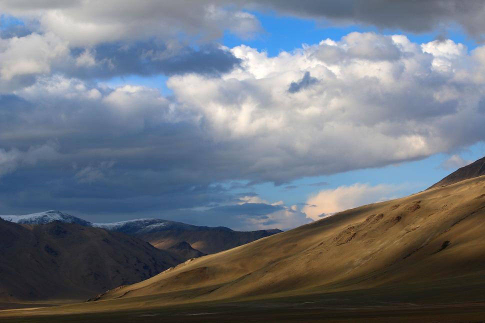 Free Image of Majestic Mountain Range With Clouds in the Sky 