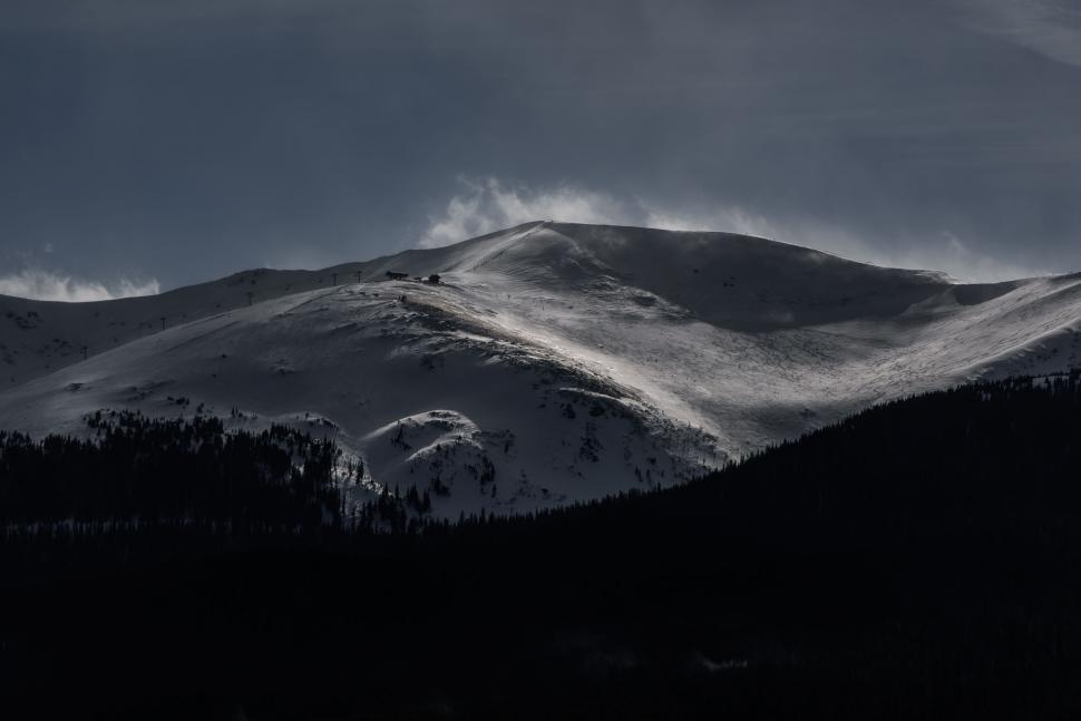 Free Image of Snow-Covered Mountain Under Cloudy Sky 