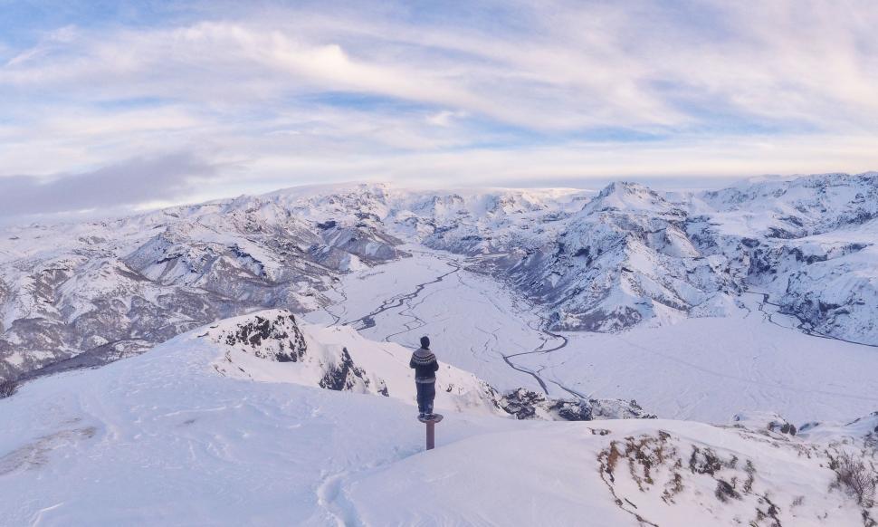 Free Image of Person Standing on Snow-Covered Mountain 