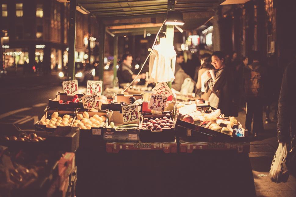 Free Image of Group of People Standing Around Table Filled With Food 