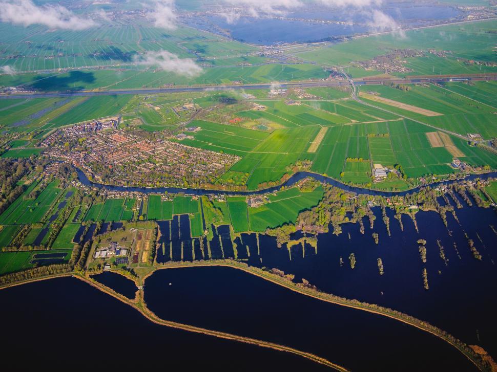 Free Image of Vast Body of Water Encircled by Verdant Fields 