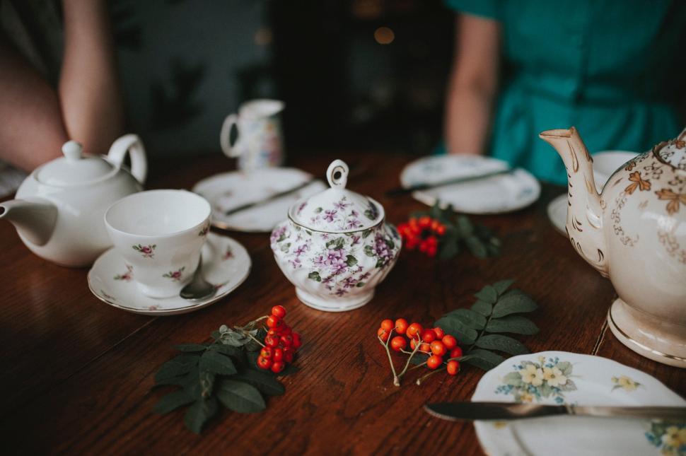 Free Image of Wooden Table Adorned With Tea Pots and Plates 