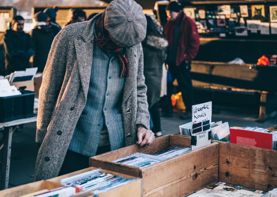 Free Image of Man Standing in Front of Table Filled With Books 