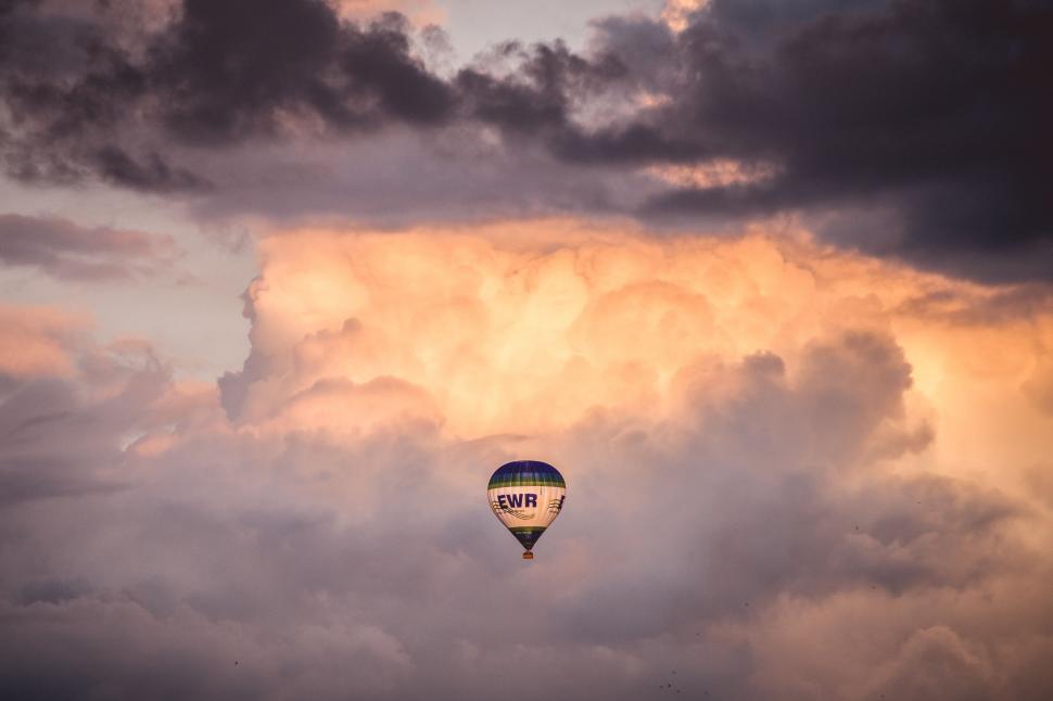 Free Image of Hot Air Balloon Flying Through Cloudy Sky 