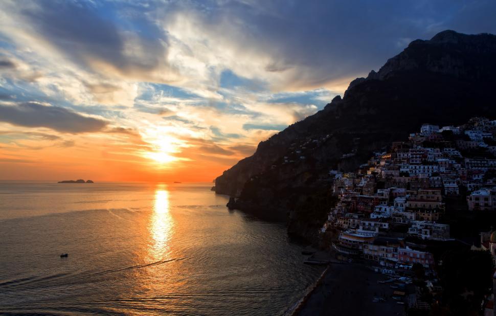 Free Image of Sun Setting Over Ocean With Boat 