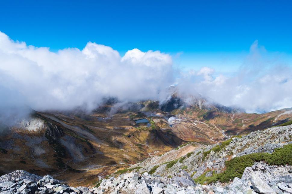 Free Image of Majestic Mountain Range With Clouds in the Sky 