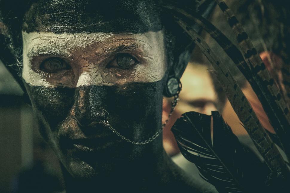Free Image of Man With Painted Face and Feathers 