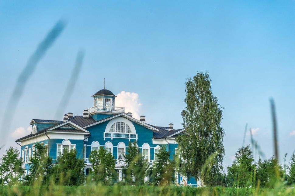 Free Image of Blue and White House Surrounded by Tall Grass 