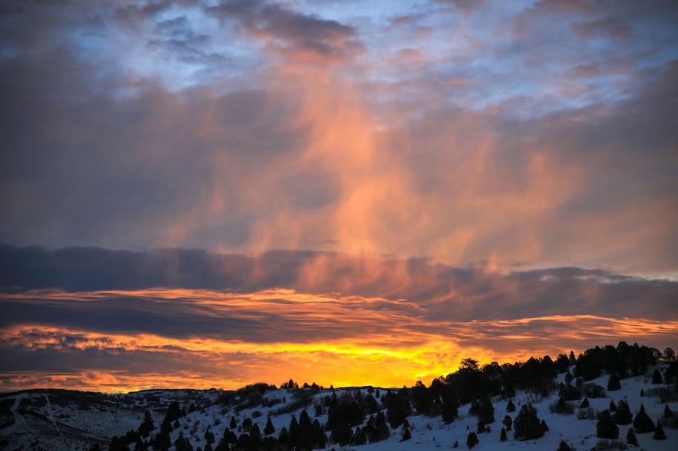 Free Image of Sun Setting Over Snowy Mountain 