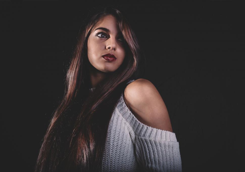 Free Image of Woman With Long Brown Hair Wearing a Sweater 