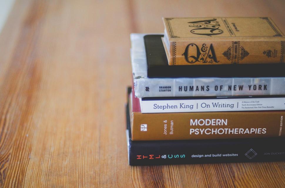 Free Image of Stack of Books on Wooden Table 