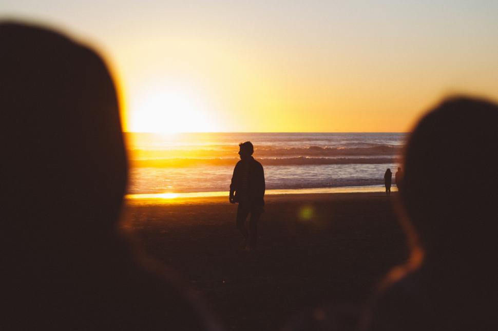 Free Image of Group of People Standing on Top of a Beach 