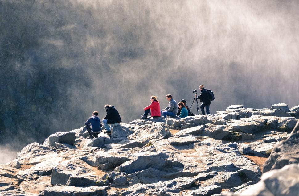 Free Image of Group Of People Standing On Top Of A Rocky Mountain 