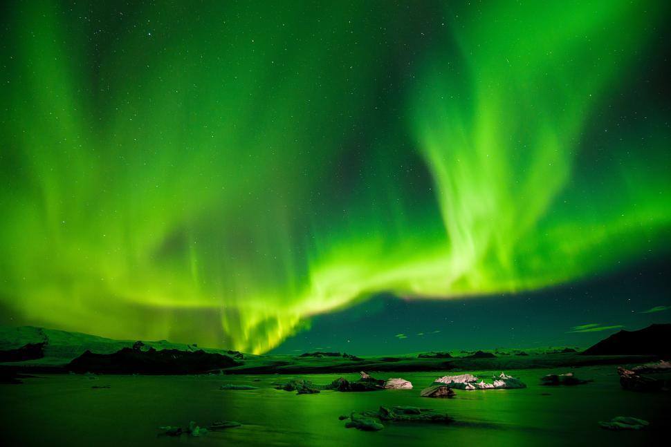 Free Image of Vibrant Green and Blue Sky Illuminated by Numerous Lights 
