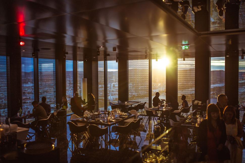 Free Image of Group of People Sitting at Tables in a Restaurant 