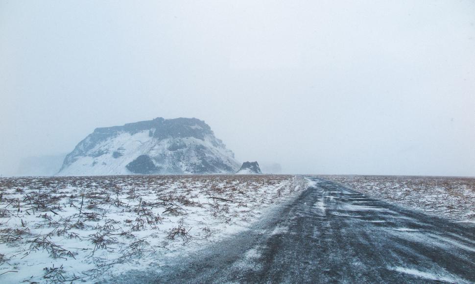 Free Image of Snow Covered Road With Mountain in Background 
