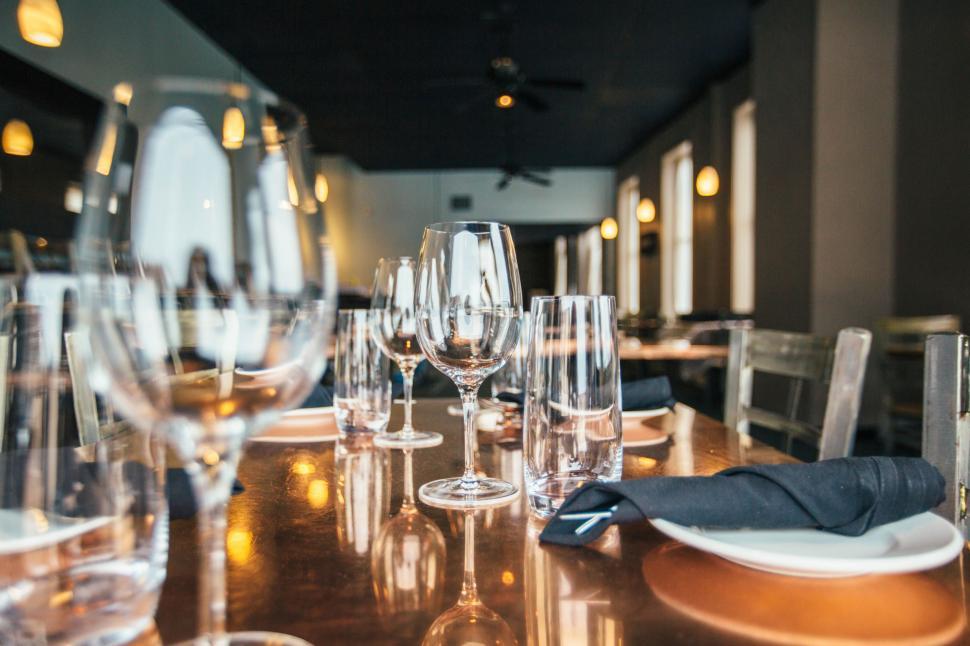 Free Image of Wooden Table Covered With Many Wine Glasses 