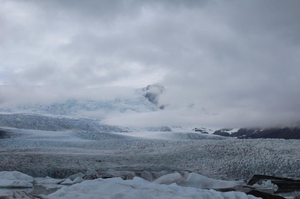 Free Image of Snow-Covered Mountain Under Cloudy Sky 
