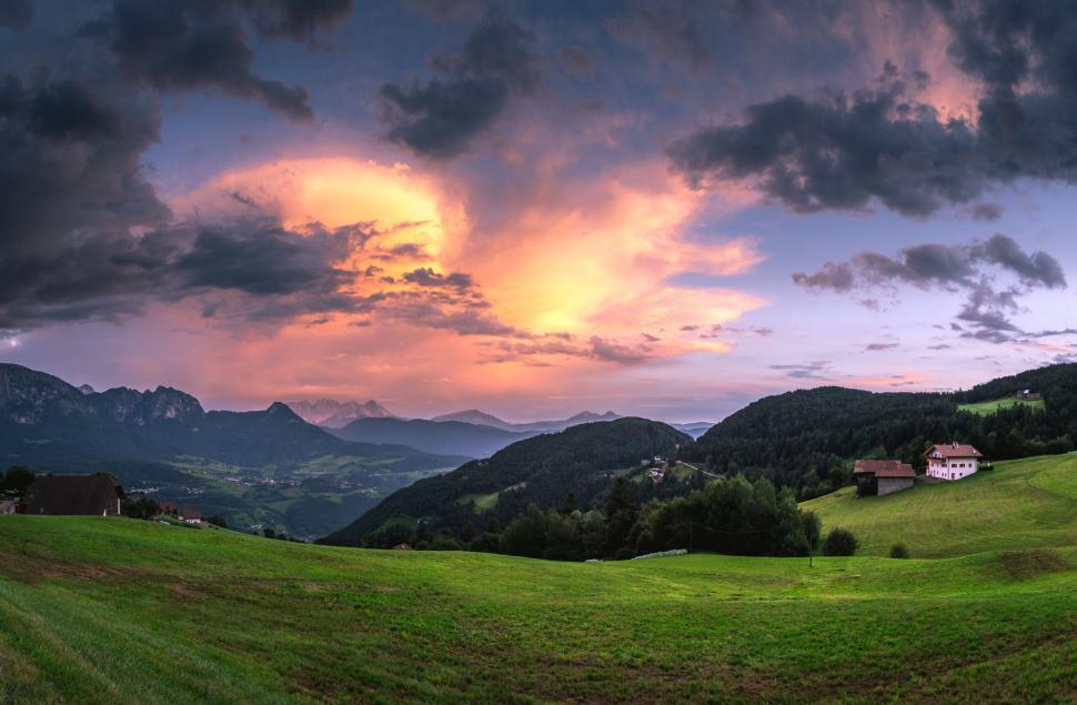 Free Image of Green Field With Mountains in the Background 