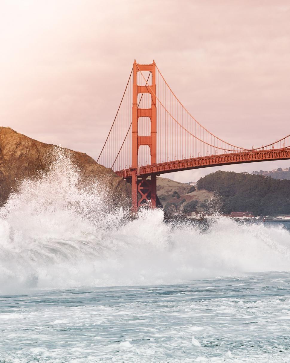 Free Image of Large Body of Water With Bridge in Background 
