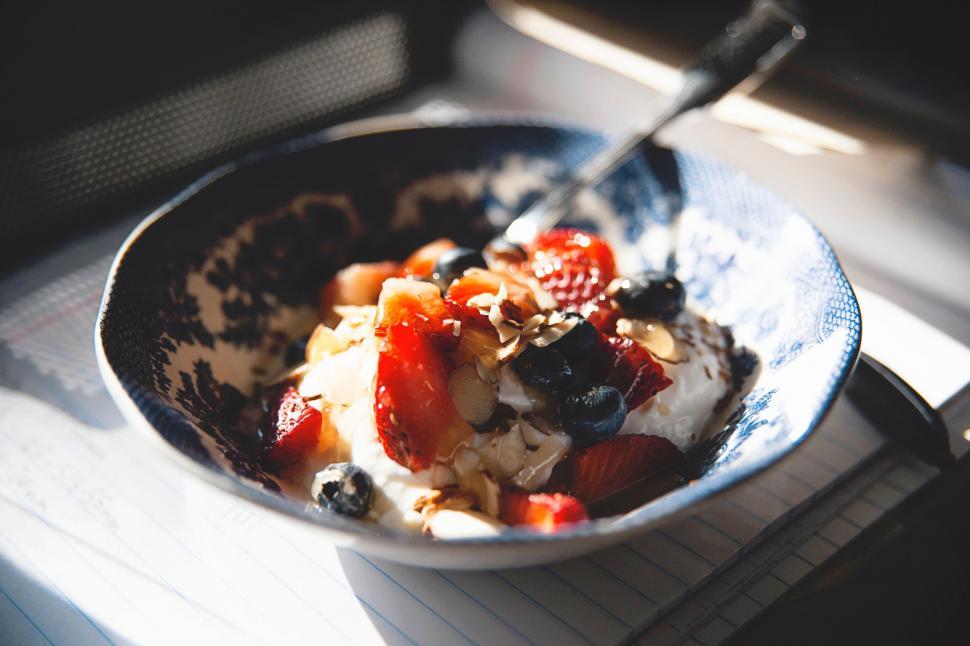 Free Image of Bowl Filled With Fruit and Yogurt on Table 