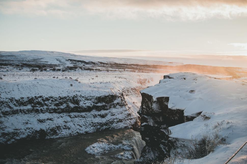 Free Image of Man Standing on Top of Snow Covered Mountain 