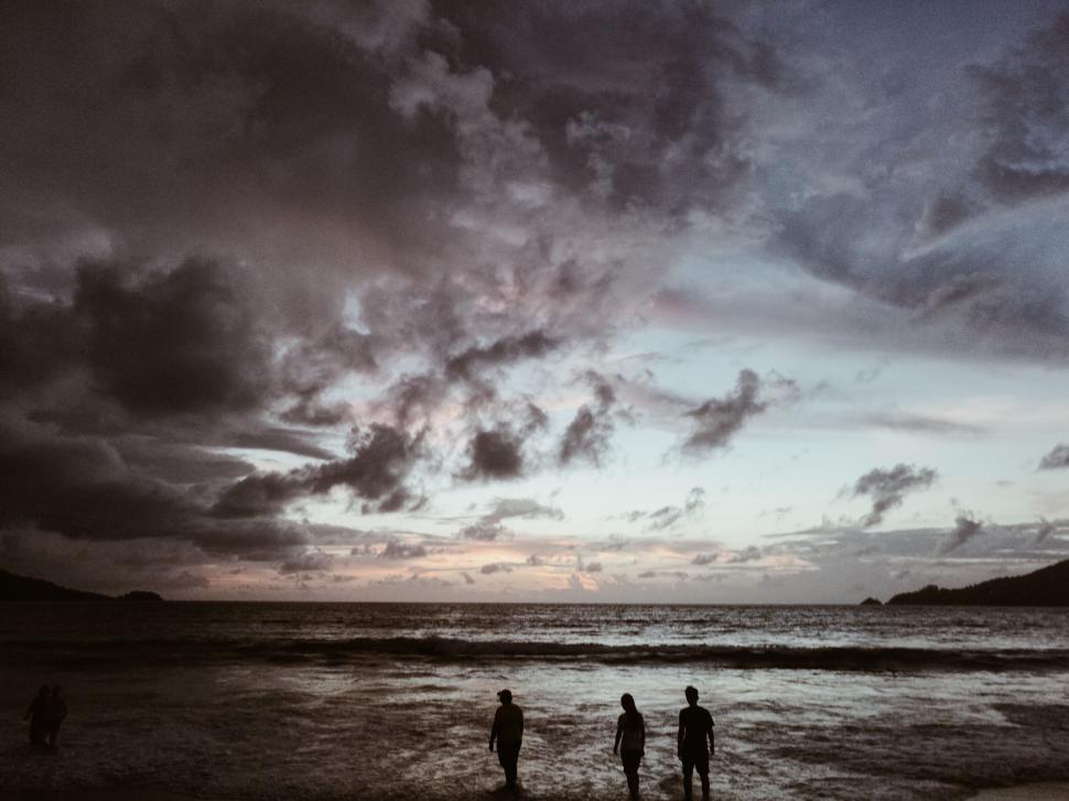 Free Image of Couple Standing on Top of Beach 