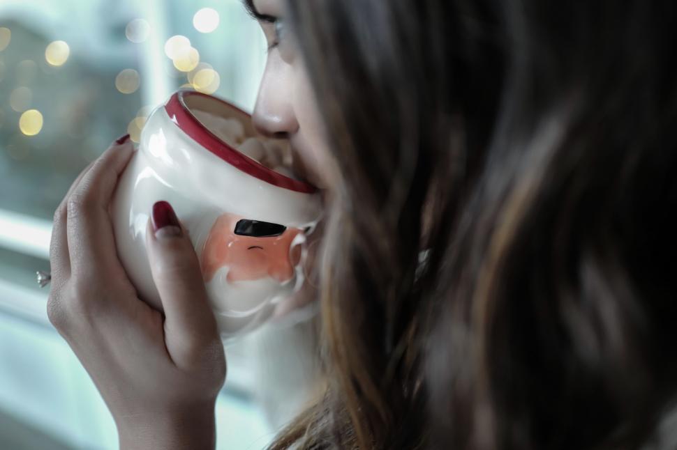 Free Image of Woman Holding a Coffee Cup 