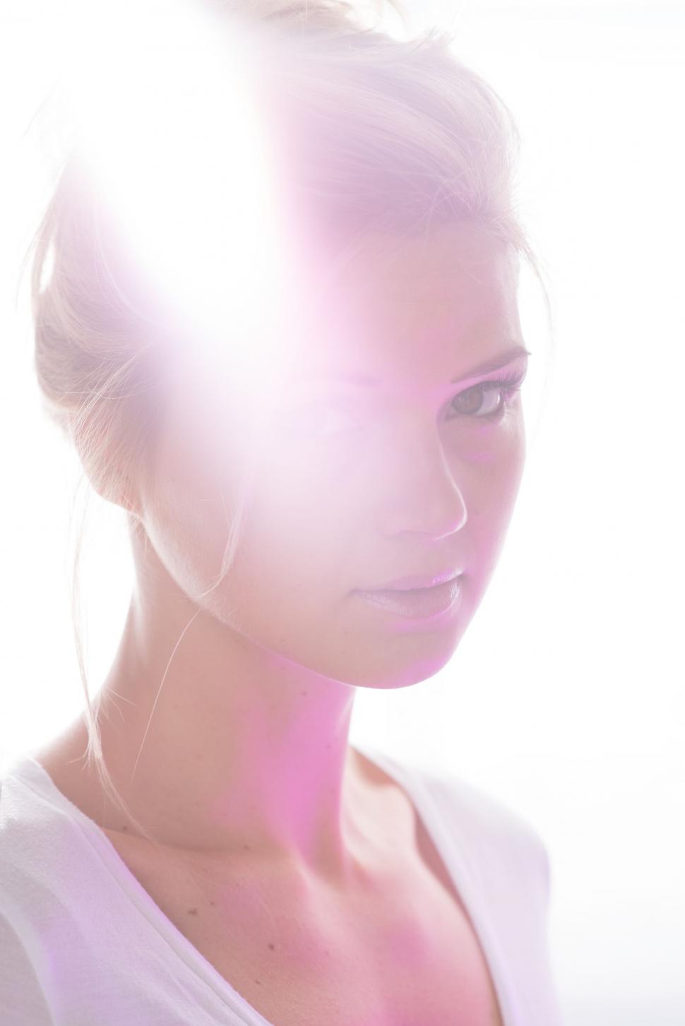 Free Image of Woman in White Shirt Looking at Cell Phone 