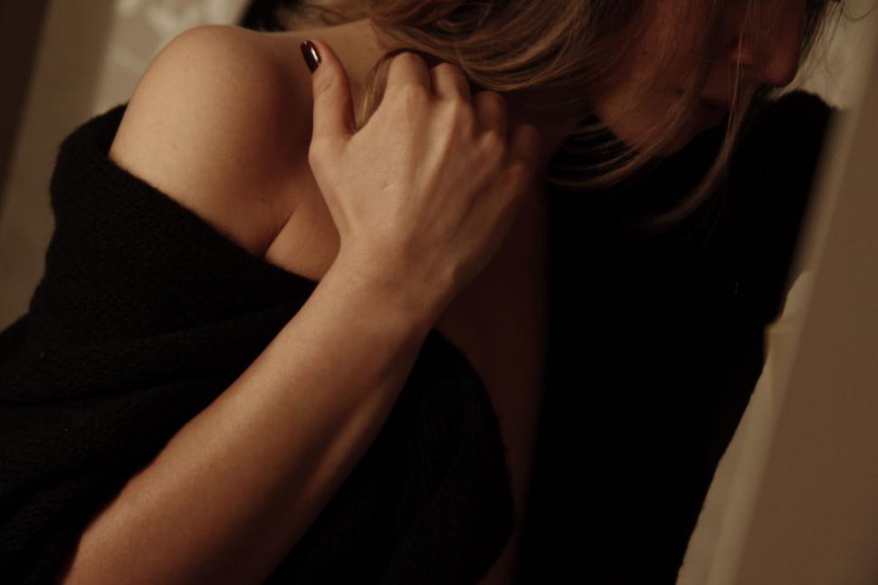 Free Image of Woman in Black Dress Talking on Cell Phone 