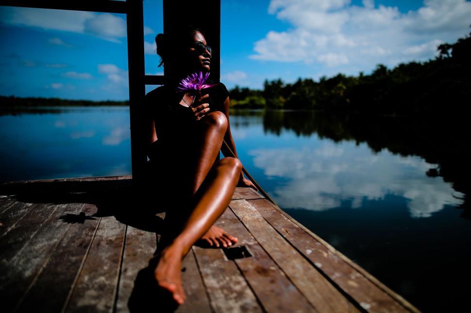 Free Image of Person Sitting on Dock by Water 