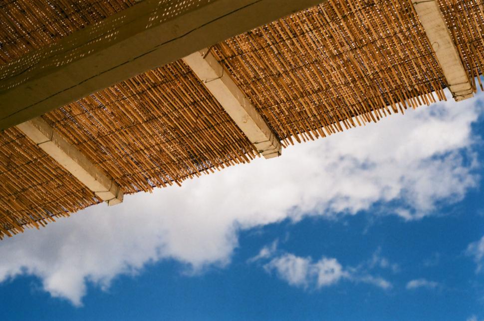 Free Image of Sky View Under Straw Umbrella 