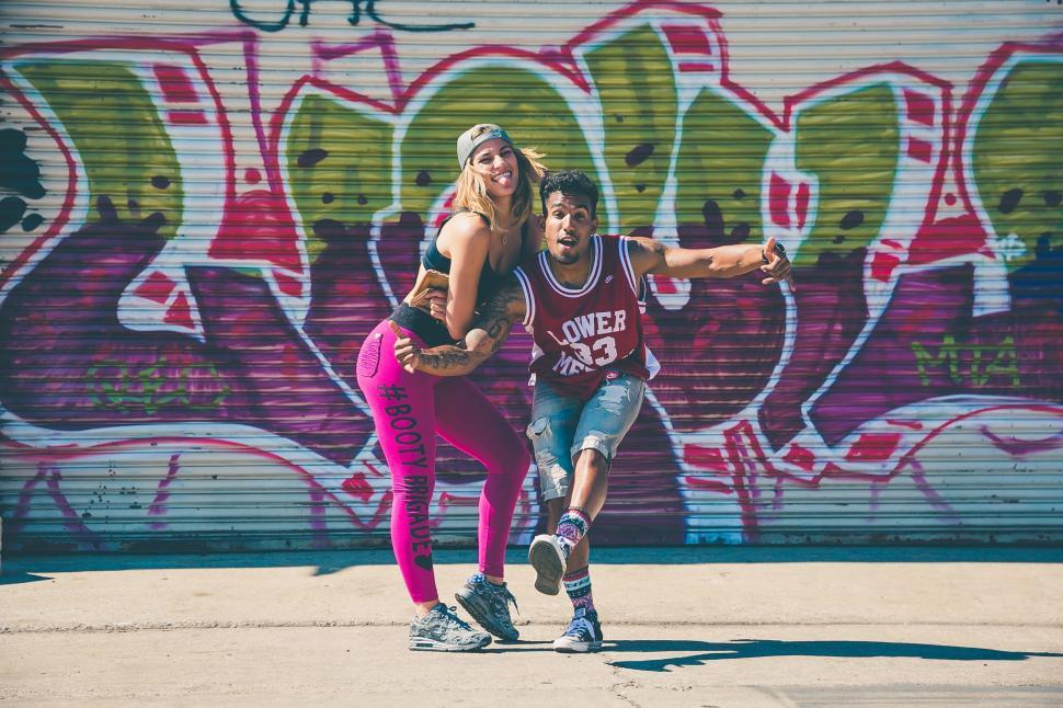 Free Image of Couple Standing in Front of Wall 