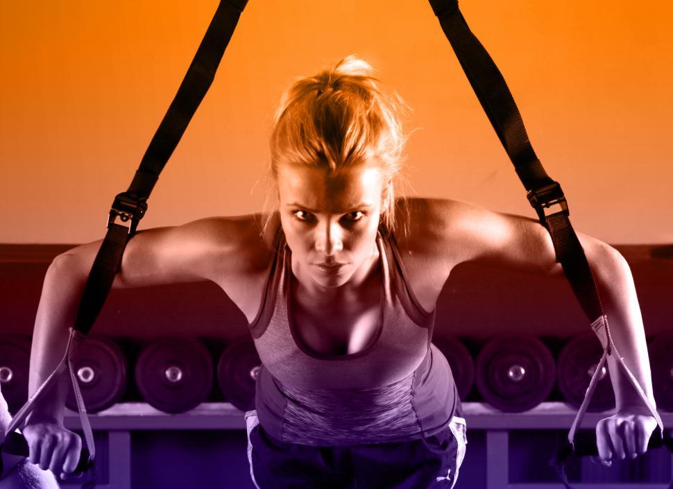 Free Image of Young Attractive Woman Training with HTRX Fitness Straps in the  