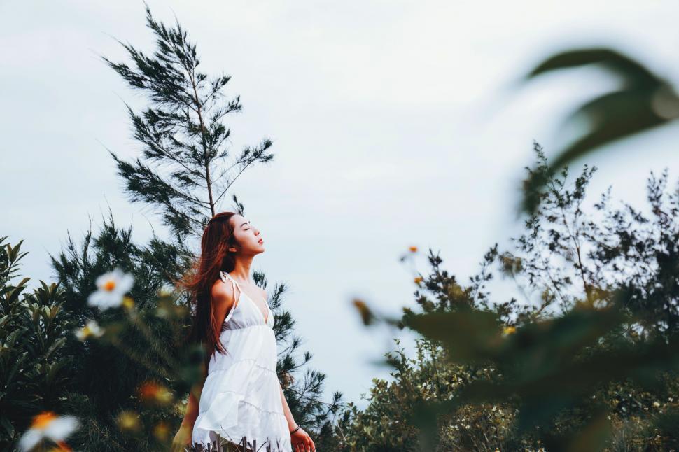 Free Image of Woman in White Dress Standing in Field 