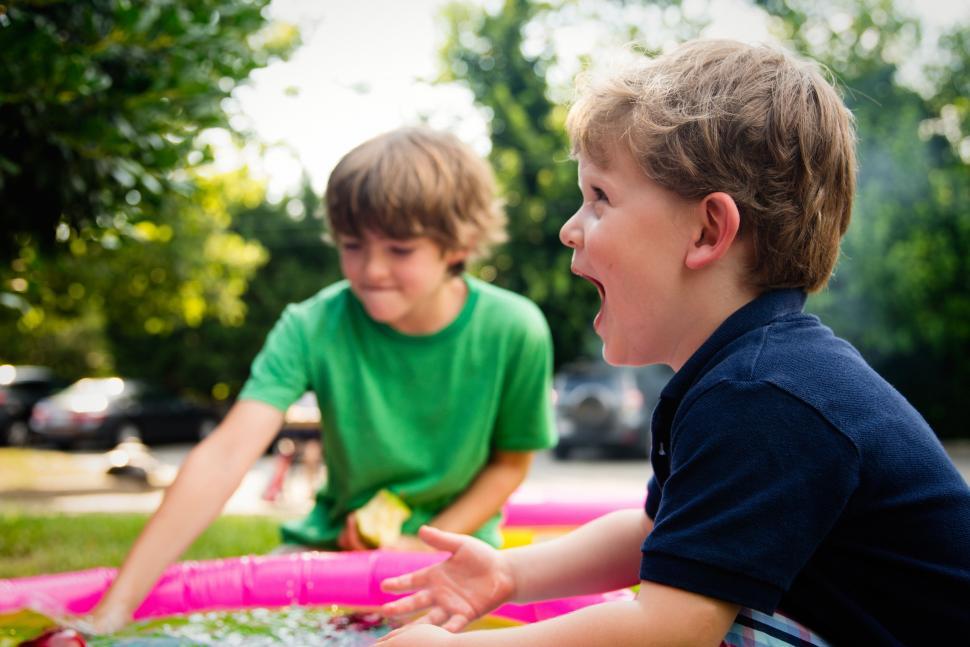 Free Image of Two Children Sitting in the Grass 