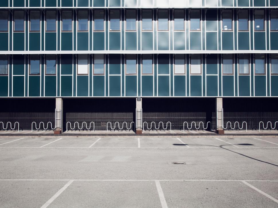Free Image of Empty Parking Lot in Front of Tall Building 