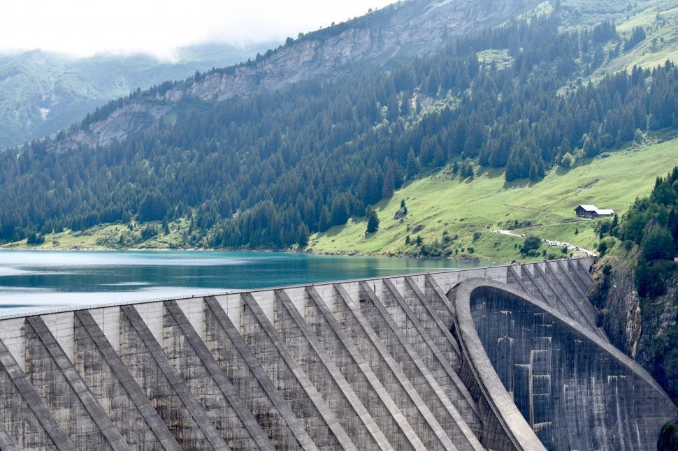 Free Image of Man Riding Skateboard on Side of Dam 