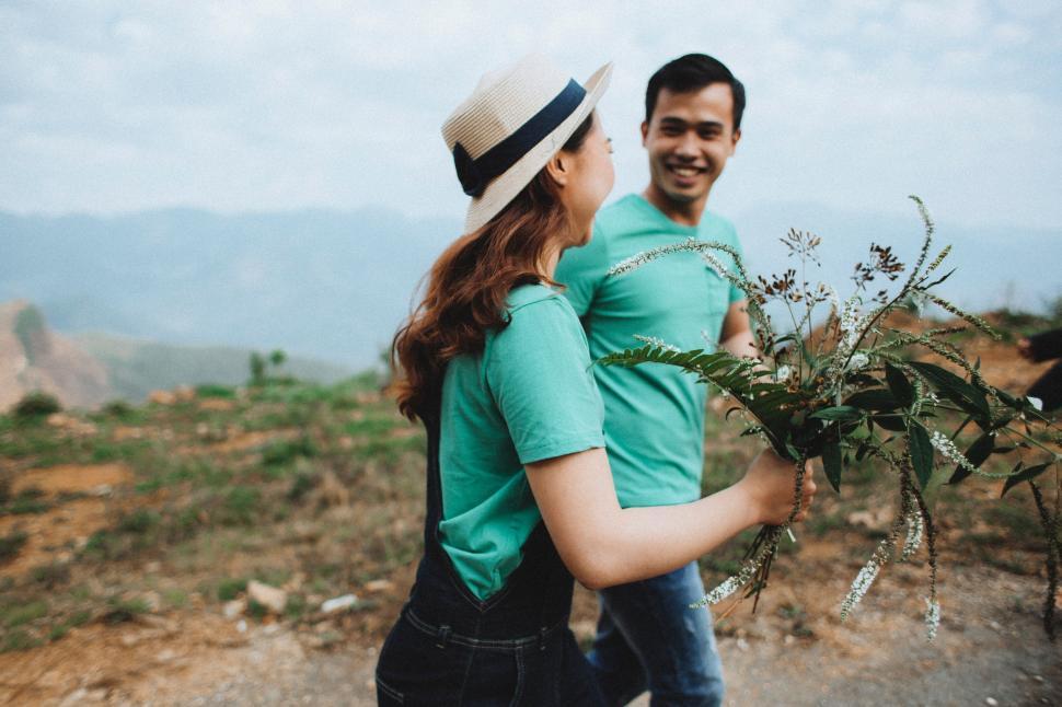 Free Image of Man Holding Woman on Top of Mountain 