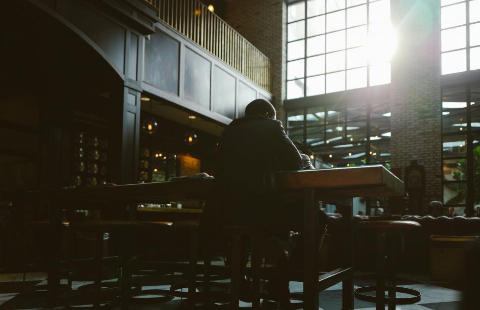 Free Image of Man Standing at Table in Large Room 