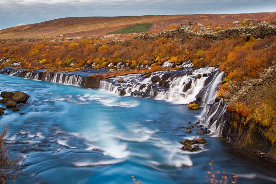 Free Image of River Flowing Through Lush Green Hillside 