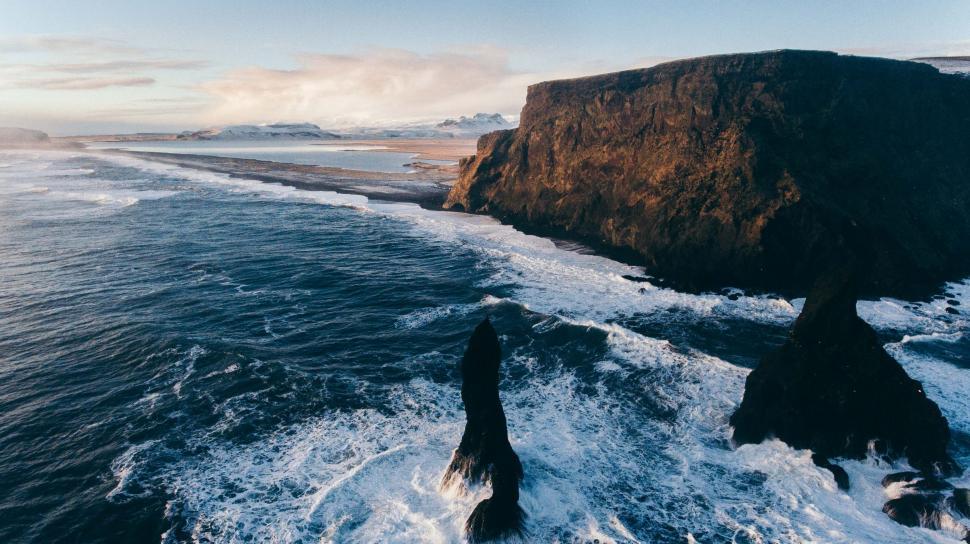 Free Image of Majestic Water Body Alongside Rocky Cliff 