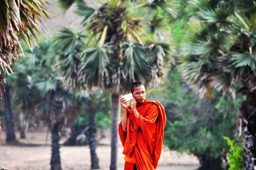 Free Image of Man in Red Robe Holding Cup of Coffee 
