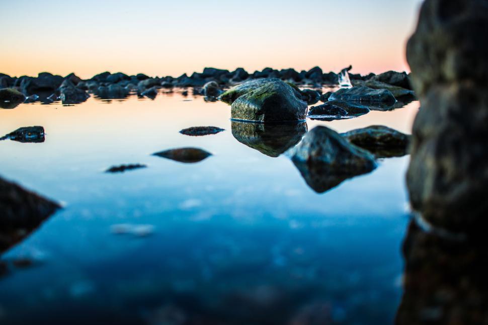Free Image of Rocky Shoreline Surrounding Water 