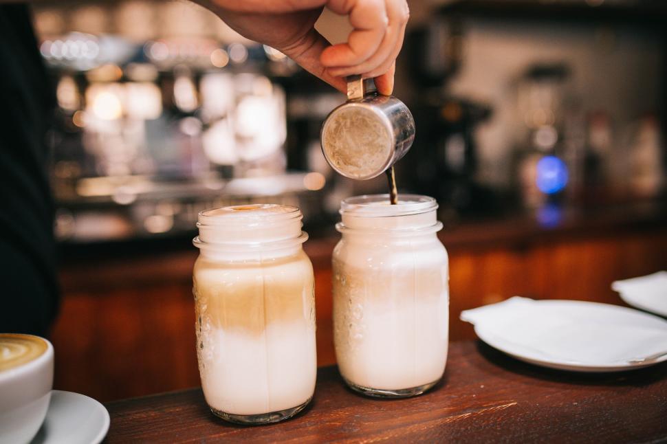 Free Image of Person Pouring Sugar Into Jar With Spoon 