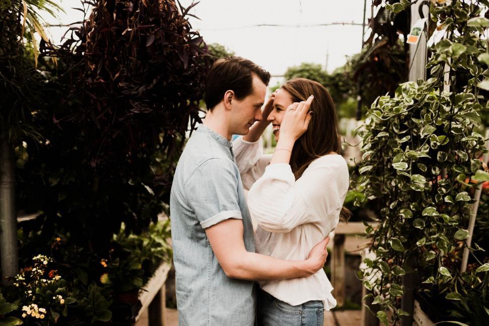 Free Image of Man and Woman Standing in Greenhouse 